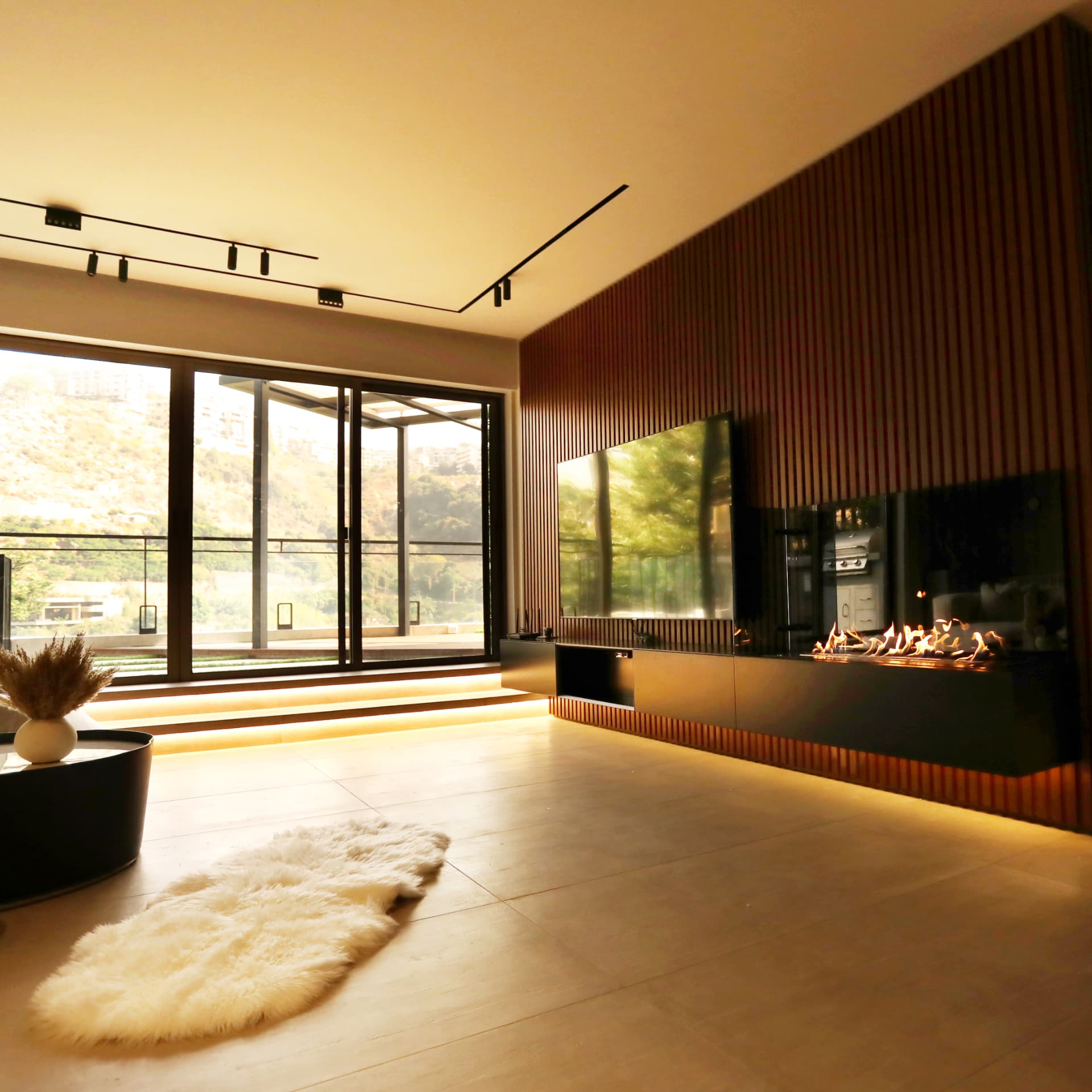 Media wall with screen, linear fire and concealed step lighting