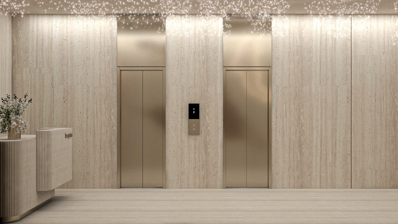Bronze lift doors set in travertine cladding beneath a scattered light installation