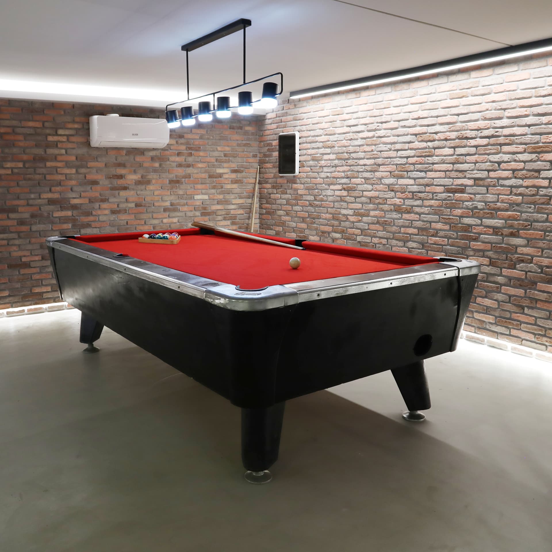 Games room with pool table and exposed brick walls